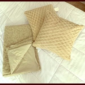 Beige plush pillows and throw